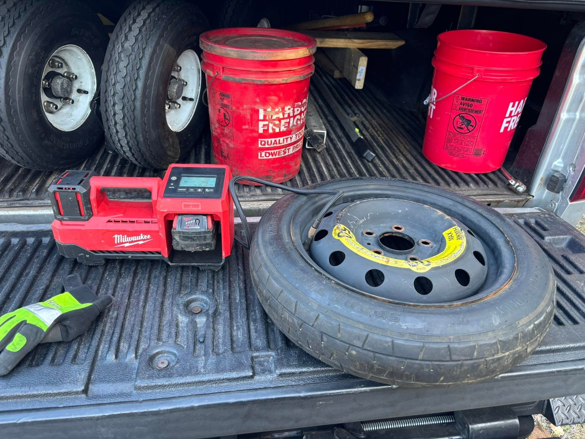 JF Drives truck bed with spare tire, Milwaukee inflator, and roadside service equipment ready for a call
